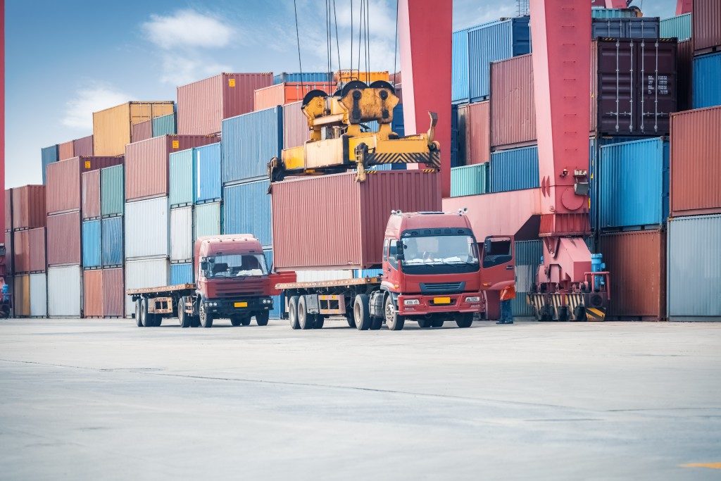 industrial crane loading containers in a cargo freight truck