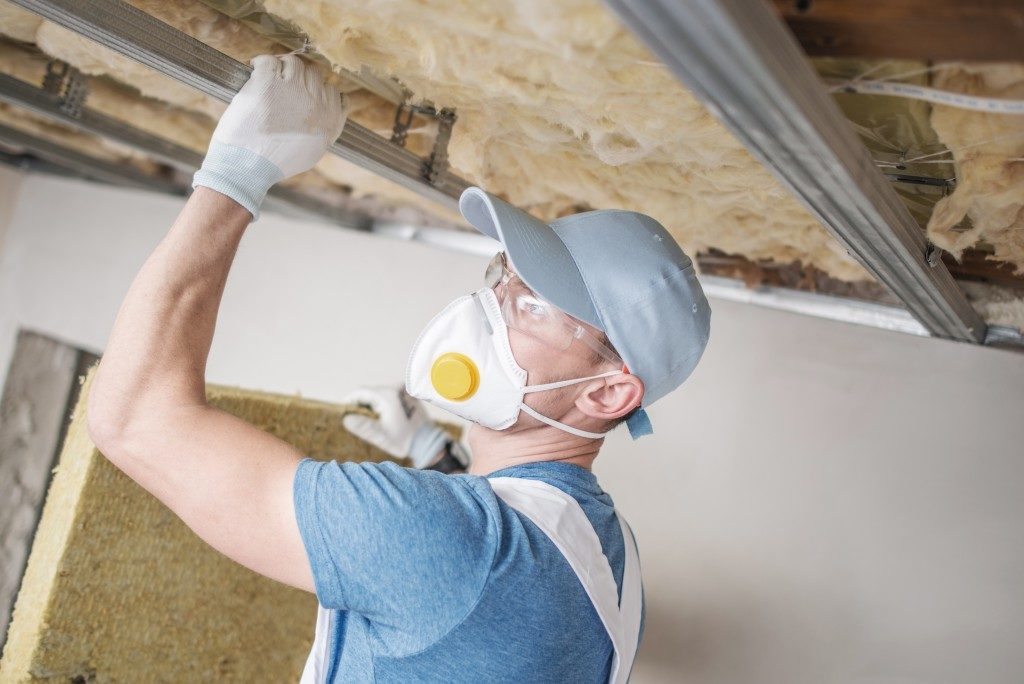 contractor installing insulation