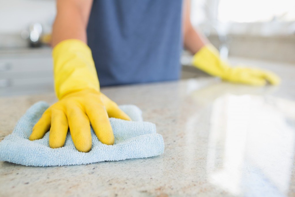 woman cleaning the kitchen counter