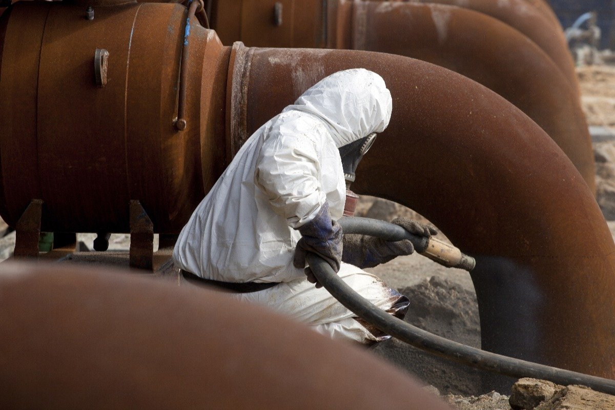 man cleaning a pipe