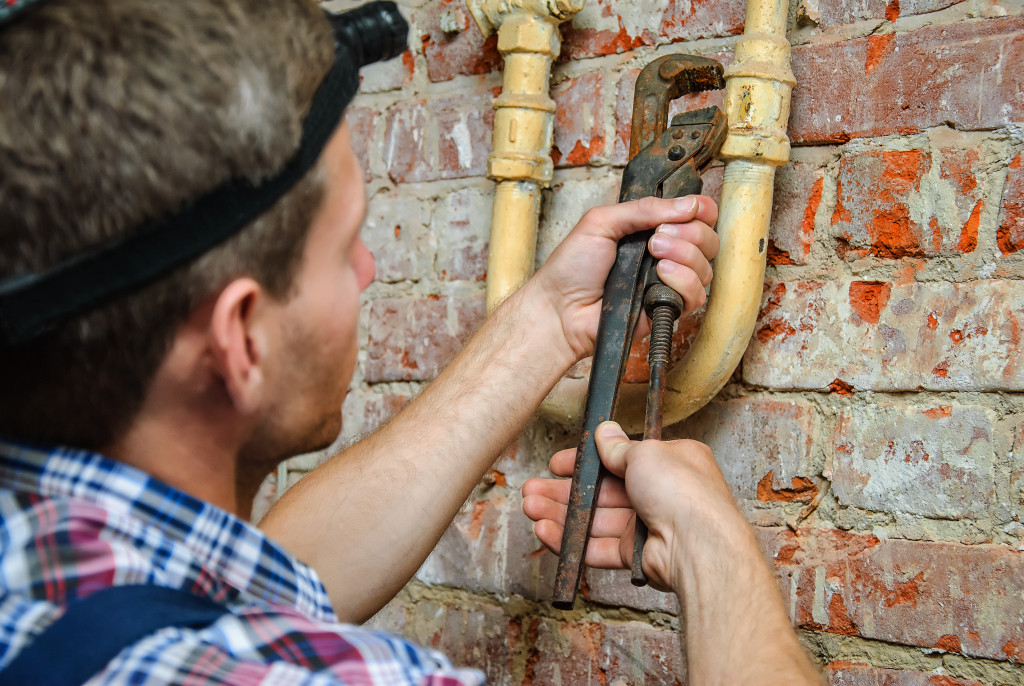 A plumber fixing a pipe
