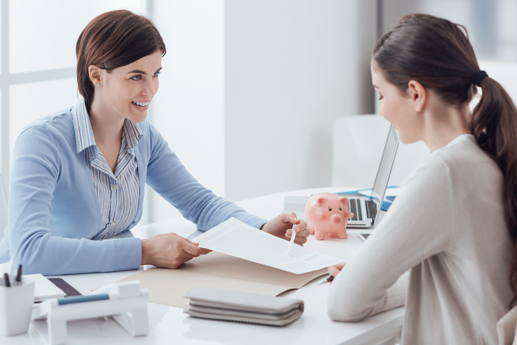 Young woman getting a loan from a financial institution.